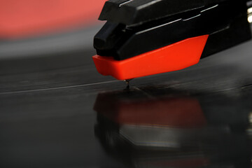 Needle of vinyl player is mounted on record. Closeup on macro photos.