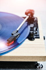 Classic vinyl record player closeup with contoured sunlight.