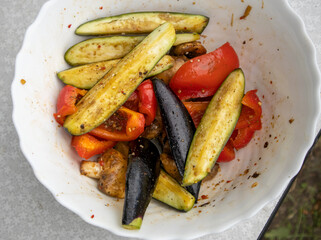 Grilled vegetables -bell peppers, zucchini, eggplant on a white plate, top view, close-up