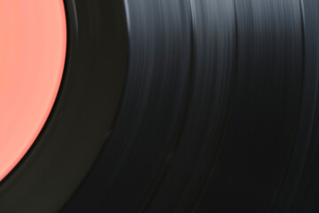 Sound tracks on a vinyl black record closeup macro photo.