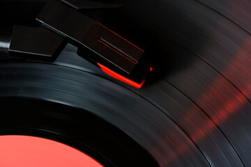 Black vinyl record and needle for playing music from vinyl top view.