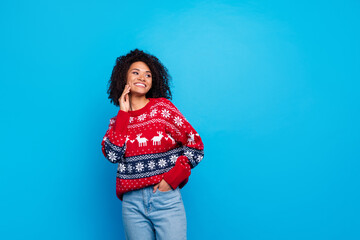 Portrait of girl young age student touching cheek looking empty space gifts store winter holidays season isolated on blue color background
