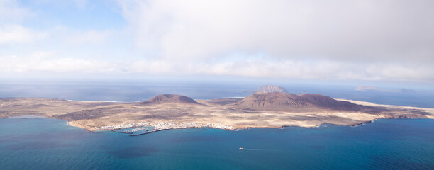 Panoramic of La Graciosa Island and Clear mountain island seen from the river viewpoint. Lanzarote. Canary Islands. Spain