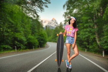 Portrait of carefree young girl riding skateboard