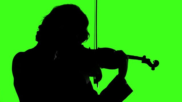 Silhouette of a Young Man Playing The Violin on Green Background. You can replace green screen with the footage or picture you want with “Keying” effect in After Effects (check out tutorials). 