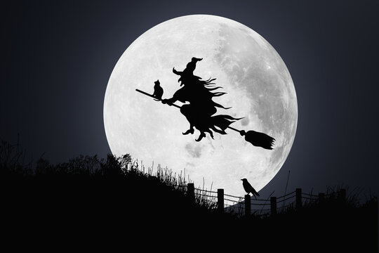 Backlit Witch sitting on a broomstick flying across a full moon with a hill as the foreground. Illustration of the concept of witchcraft, witch hunting and halloween