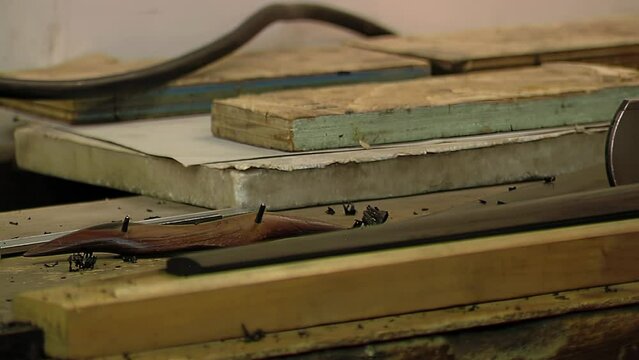 A Man Repairing a Violin in Violin Repair Workshop. Close Up. 