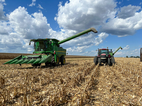 Farm land near Evansville, IL with a combine and tractor.