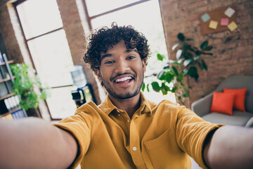 Photo of cheerful funny man recording video streaming filming working day workspace indoors