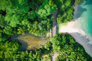 : Drone bird eye view of Anse louis, Louis beach, white sandy beach, road, river and turquoise water Mahe Seychelles