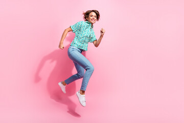 Full body profile portrait of energetic active lady jump run empty space isolated on pink color background - obrazy, fototapety, plakaty