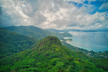 Fototapeta na wymiar Drone shot from tea factory, view from the south west to west coast of Mahe behind mont sephale, cloudy sky, Mahe Seychelles