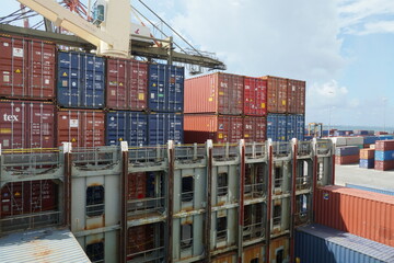 Cell guides and lashing bridges of container vessel with cranes ready for loading of containers in...