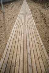 Wooden planked path on a sandy beach