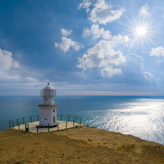 closeup lighthouse stay on marine cape at summer sunny day