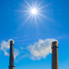 pair of chimney on the blue sky with sparkle sun, outdoor indysty scene