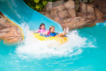 Kids on water slide. Family in aqua theme park. - obrazy, fototapety, plakaty