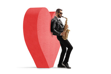 Romantic male musician in a leather jacket playing a saxophone