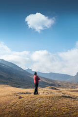 A man arms crossed watching his land, enjoying the view of the beautiful landscape vertical