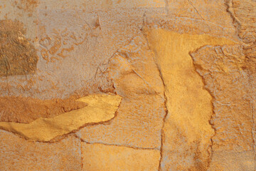 Gold, bronze and beige paper collage paper frame wall. Abstract glow texture copy space background.