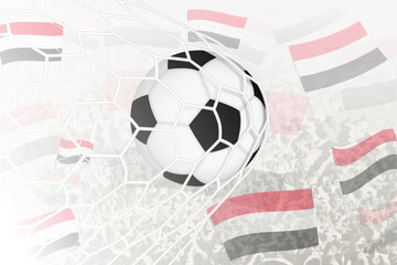 National Football team of Yemen scored goal. Ball in goal net, while football supporters are waving the Yemen flag in the background.