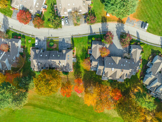  aerial view of apartment community beside golf course in autumn
