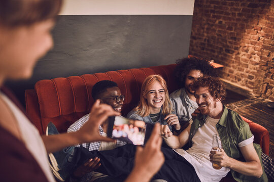Group of friends capturing a joyful moment at a bar