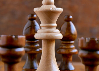 chess pieces on a wooden chessboard