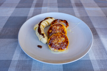 Traditional Ukrainian cheesecakes with bananas and chocolate 