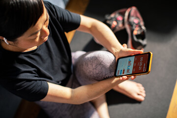 Woman checking her fitness progress on a smartphone