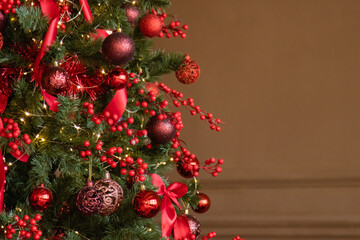 Christmas interior in red and brown tones. Beautiful furniture in the living room, Christmas tree with toys