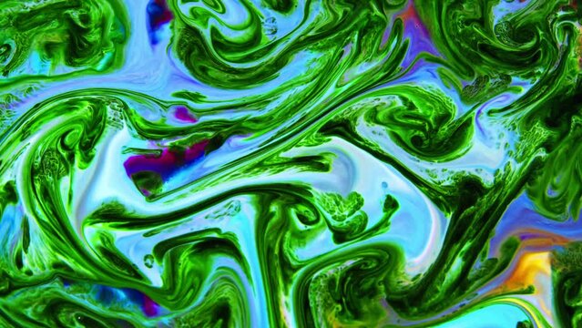 This stock video shows what happens when milk is introduced to a mixed-color paint. The colors swirl and form new shades of paint slowly flowing into a marbled mix. Use this abstract background by