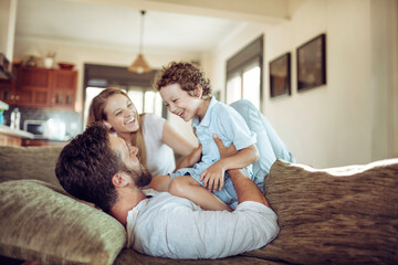 Joyful family sharing a playful moment in their living room