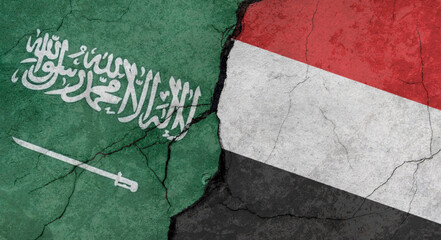 Saudi Arabia and Yemen flags, concrete wall texture with cracks, grunge background, military conflict concept