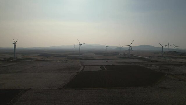Wind turbines producing electricity in a cotton field in Dikili, Izmir province, Turkey