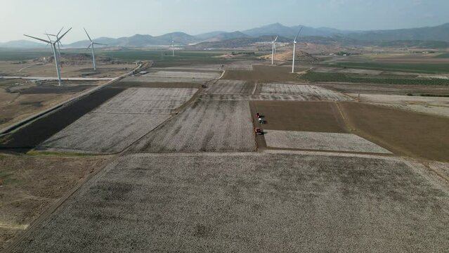 Wind turbines producing electricity in a cotton field in Dikili, Izmir province, Turkey