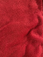 Closeup of red towel with a wrinkle in the corner