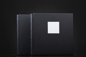 A beautiful leather bound books against a black background. Wedding photo book, family album....