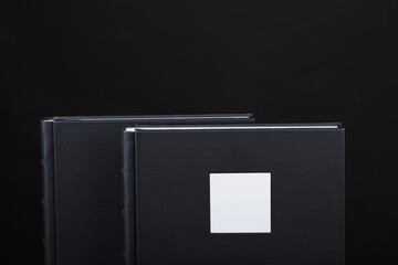 A beautiful leather bound books against a black background. Wedding photo book, family album....