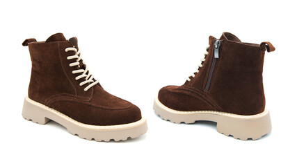 Pair of fashionable suede leather boots isolated on white background. 