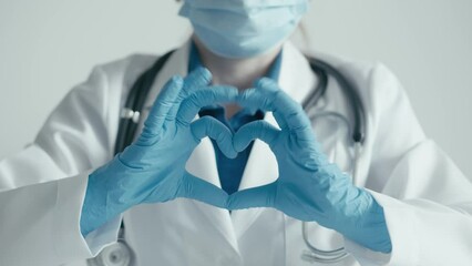 Congratulations on Valentine's Day to all doctors and medical staff, medical and pharmaceutical industries. Maintaining health on planet earth. Heart sign with both hands and the doctor's fingers
