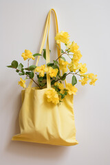 Yellow cotton bag with yellow flowers on a white background. Eco-friendly concept.