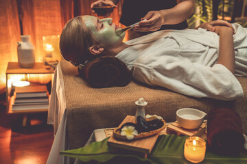 Serene ambiance of spa salon, woman customer indulges in rejuvenating with luxurious face cream...