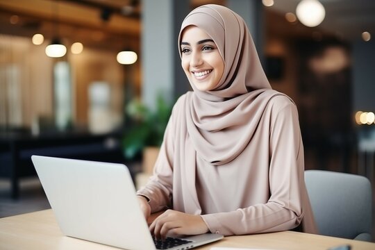  Portrait of Young Muslim Businesswoman Wearing Hijab Works on Laptop, Does Data Analysis, Website Design, Creative Development. Digital Entrepreneur Works on e-Commerce Startup Project