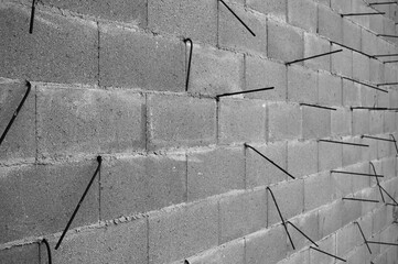 gray wall made of concrete blocks and metal reinforcement