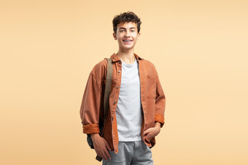 Portrait of smiling attractive teenage schoolboy with dental braces, wearing casual clothes