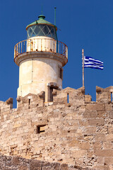 Old stone lighthouse on the breakwater in Rhodes.