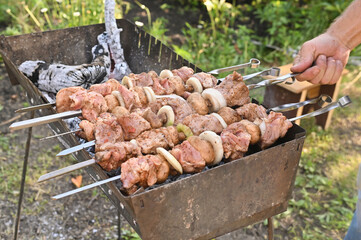 the process of cooking shish kebab from meat on the grill
