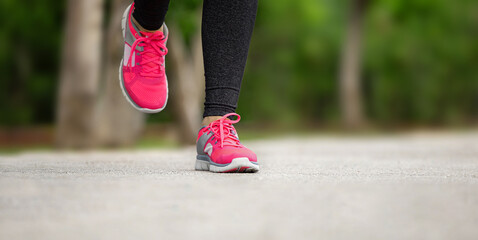 Fitness woman training and jogging in summer park, close up on running shoes. Healthy lifestyle