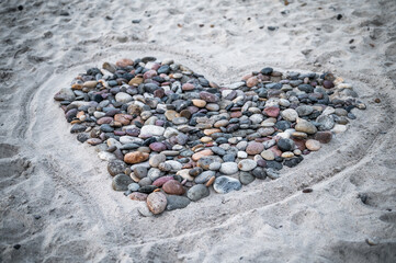 A captivating view of the undulating dune landscape in Denmark. Nature's sculpted beauty is on full display as these coastal dunes stretch along the shoreline. The interplay of sand, grass, and sky cr